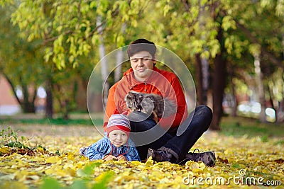 Family with cat in the autumn park