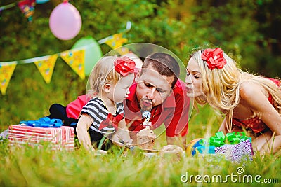 Family celebrating birthday party in green park outdoors