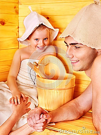 Family with child relaxing at sauna.