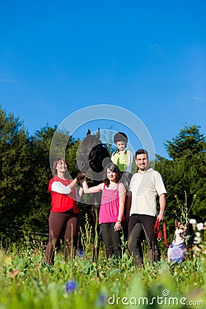 Family and children posing with horse