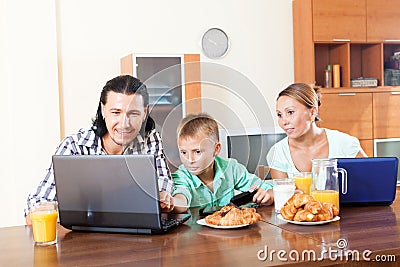 Family communicating over breakfast at home in morning