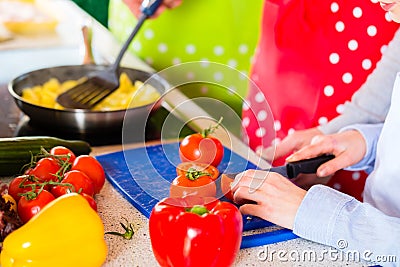 Family cooking in domestic kitchen healthy food