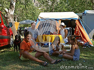 Family with dog at a camp