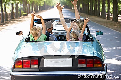 Family driving along in a sports car