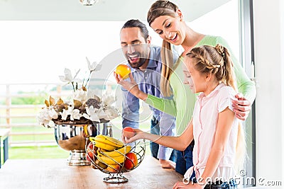 Family eating fresh fruits for healthy living in kitchen