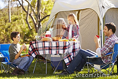 Family Enjoying Camping Holiday In Countryside