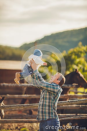 Family feeding horses in a meadow