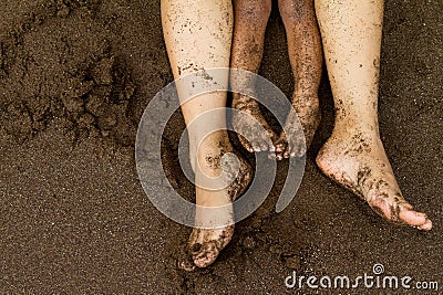 Family feet on beach sand