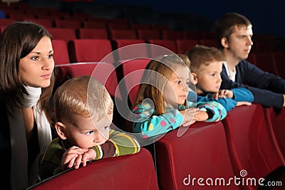 Family of five people watching a movie