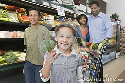 Family Of Four Shopping In Supermarket