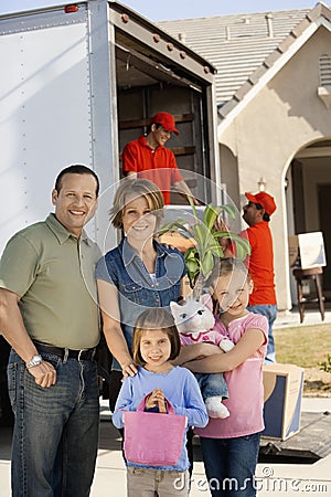 Family In Front Of Delivery Van And House