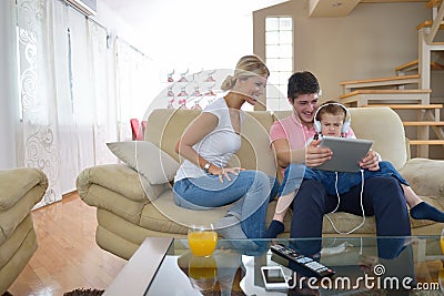 Family at home using tablet computer