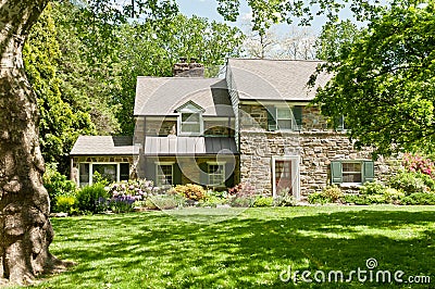 Family house with front lawn on sunny spring day