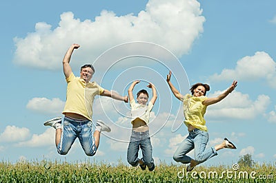 Family jumping on field