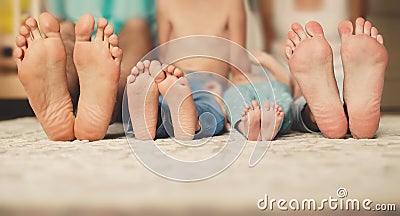 Family lying in bed together-focus on your feet.