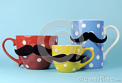 A family of mustaches on blue, red and yellow polka dot coffee and tea cups and mugs