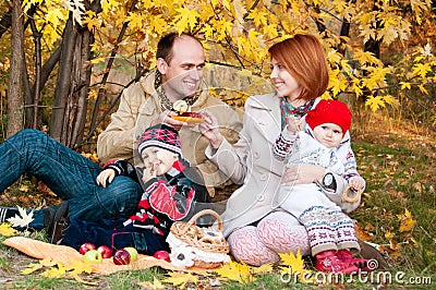 Family picnic. Family of four in the autumn forest