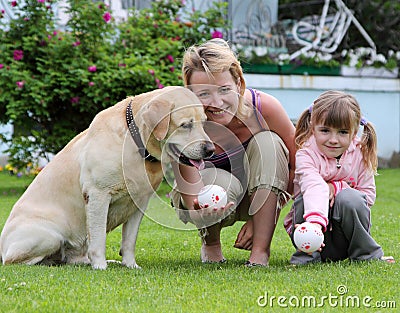 Family plays with a dog