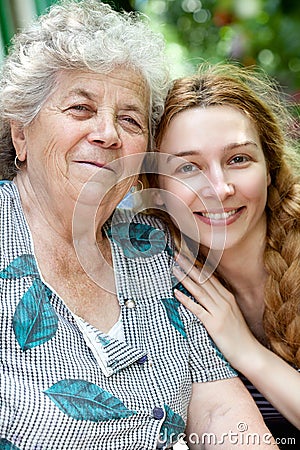 Family portrait of young woman and her grandmother