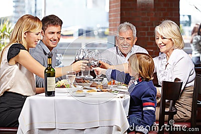 Family in restaurant clinking