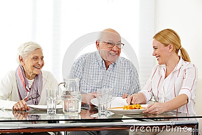 Family with senior couple eating