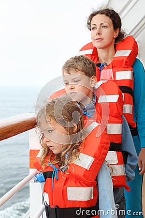 Family stand at deck of cruise liner