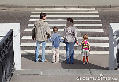 Family standing near crossover, behind