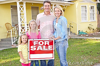 Multi Family Homes Sale on Family Standing By For Sale Sign Outside Home Stock Photography