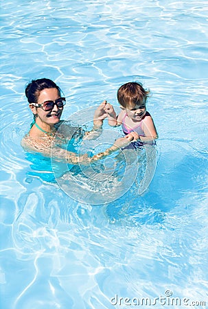 Family in swimming pool playing