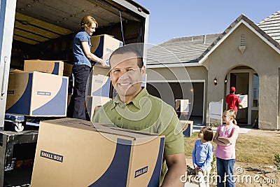 Family Unloading Delivery Van By New House