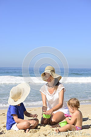 Family vacation on beach: Mother and kids