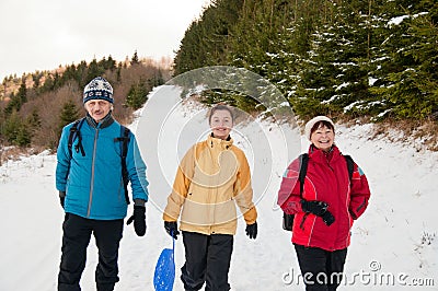 Family in winter together walking in snow