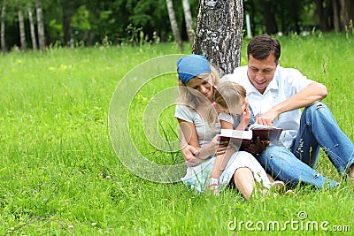 Family with a young daughter reads the Bible