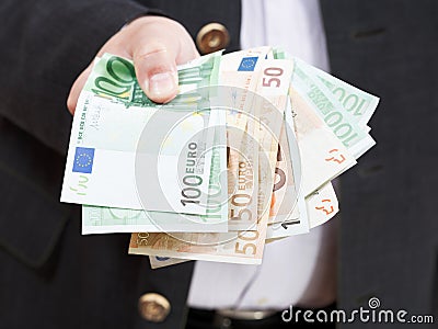 Fanned euro banknotes in male hands
