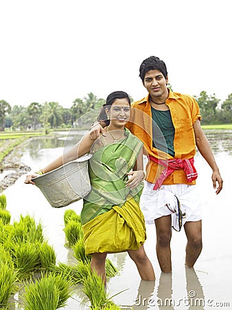 Farmer couple working in a paddy field