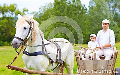 Farmer family riding a horse cart. focus on horse