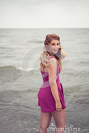 Fashion blonde at the beach sea side posing in water