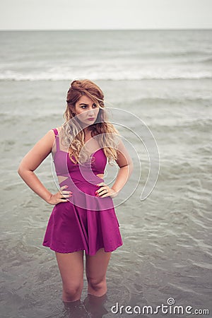 Fashion blonde at the beach sea side posing in water