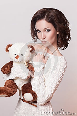 Fashion brunette woman with toy, brown curly hair girl with perfect skin and makeup. Beauty Model retro