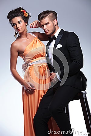 Fashion couple with man sitting on chair