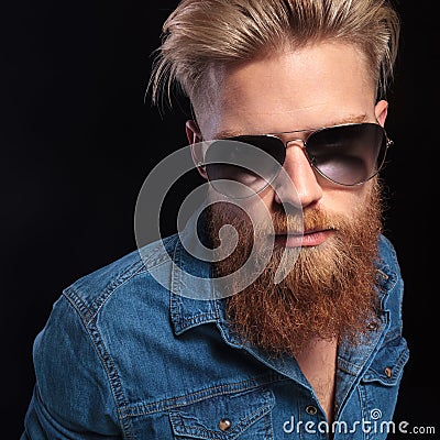 Fashion man in blue shirt wearing sunglasses posing