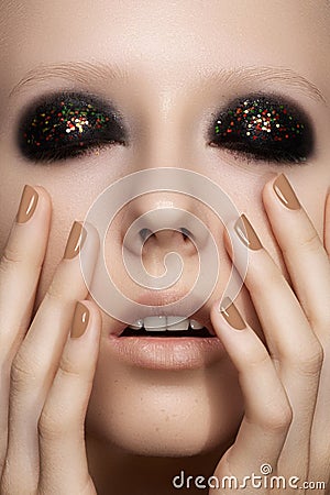 Fashion model with glitter make-up, shiny manicure