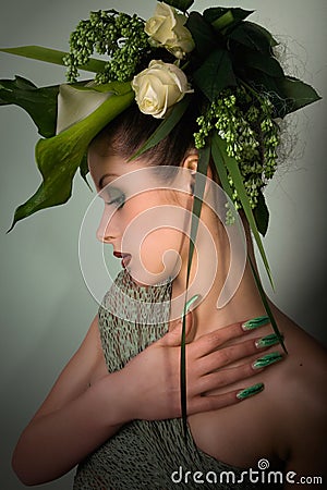 Fashion model in green design and flowers and airbrush nails