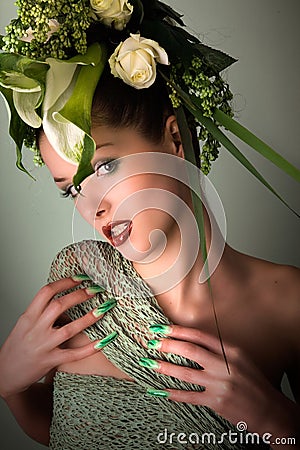 Fashion model in green design and flowers and airbrush nails