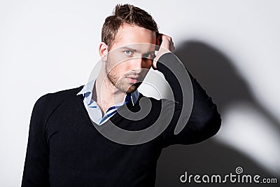 Fashion portrait of young man in black pullover.