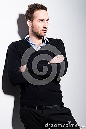 Fashion portrait of young man in black pullover.