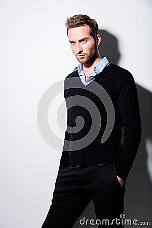 Fashion portrait of young man in black pullover.