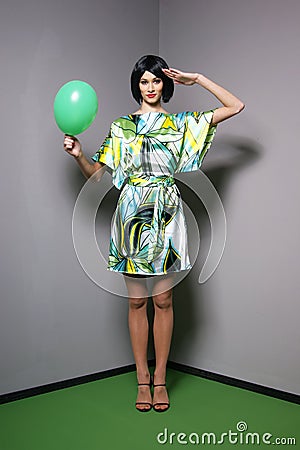 Fashion shoot of a young woman in a green dress