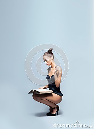 Fashion shoot of a young woman reading a book