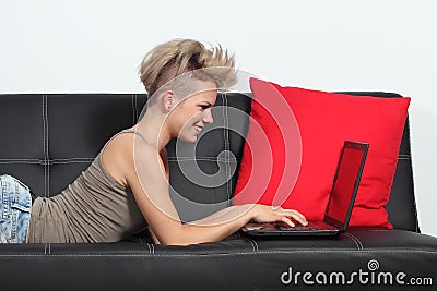 Fashion woman browsing internet in a laptop at home